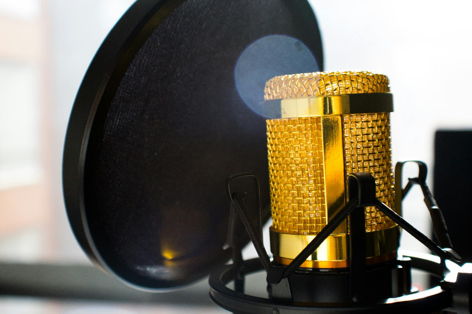 A professional-grade microphone with a pop filter, ready for recording