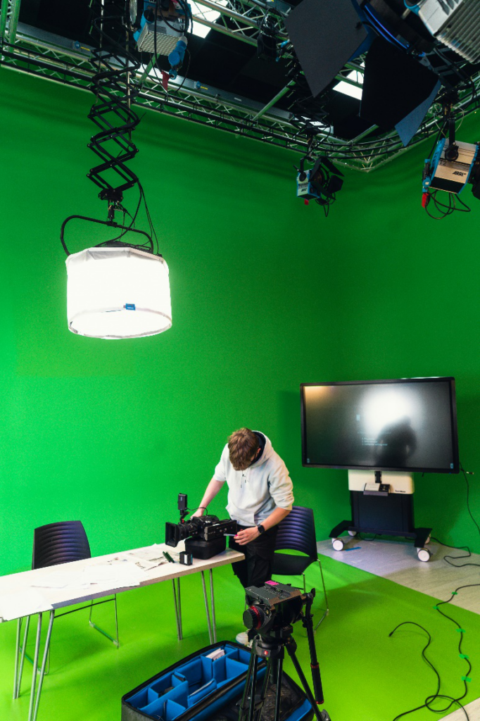 A studio is equipped with lights and cameras.