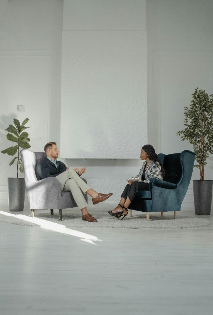 Two people sitting across from each other at a table, engaged in a interview