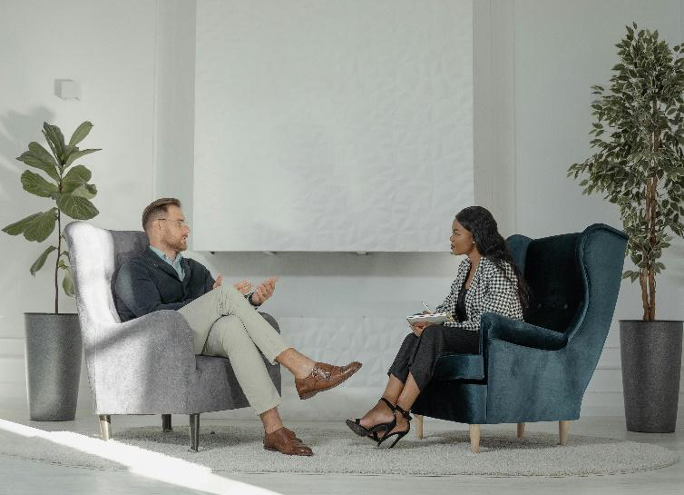 Two people sitting across from each other at a table, engaged in a interview