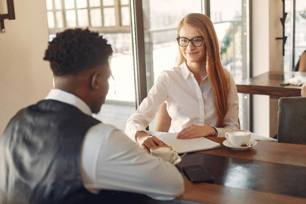 Two people sitting at a table, engaged in a discussion