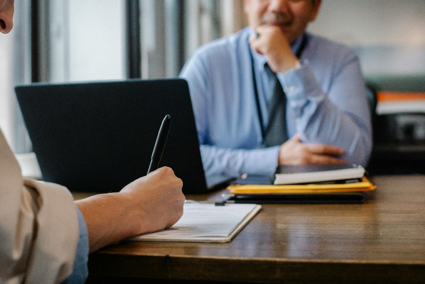Two people working together, discussing a strategy to leverage media exposure for business growth.