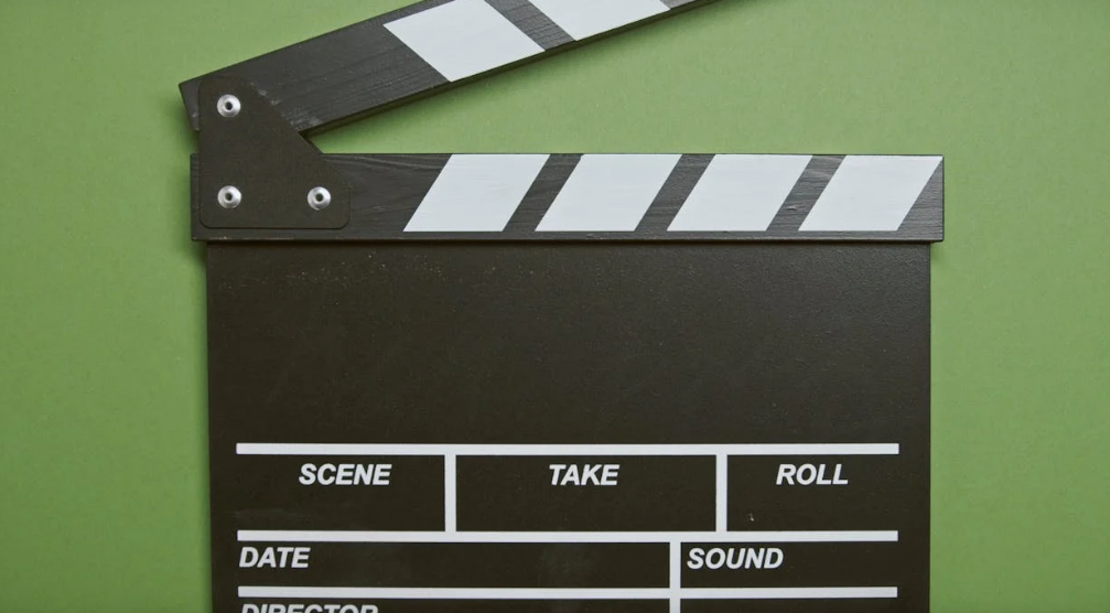 a clapper in front of a green screen