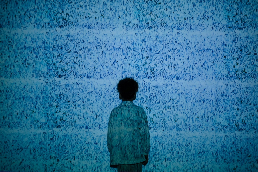 A boy standing in noise