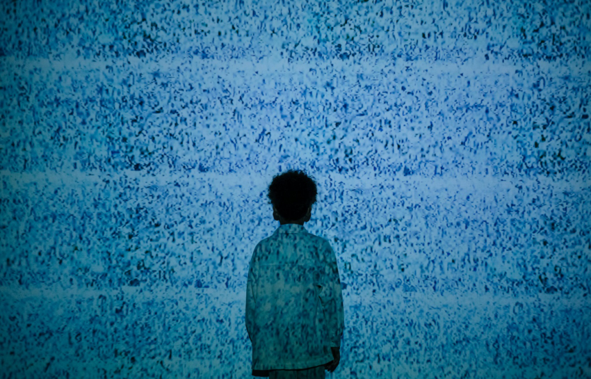 A boy standing in noise