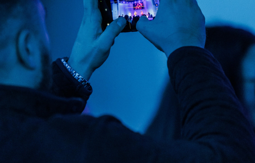 capturing live event on smartphone in blue lighting