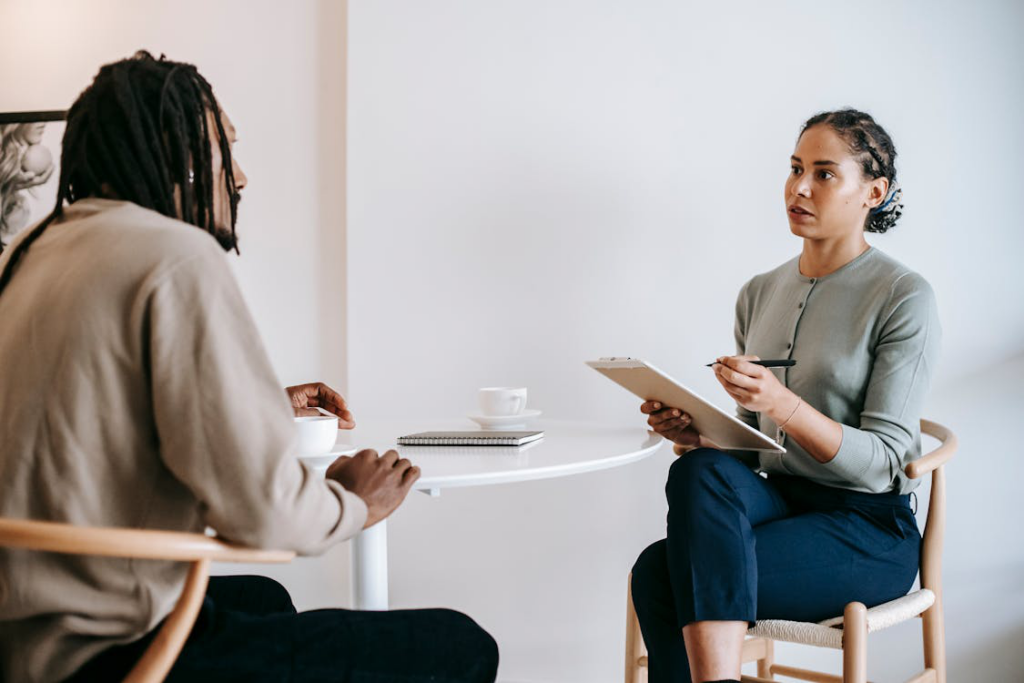 ethnic-female-psychotherapist-listening-to-black-clients-explanation