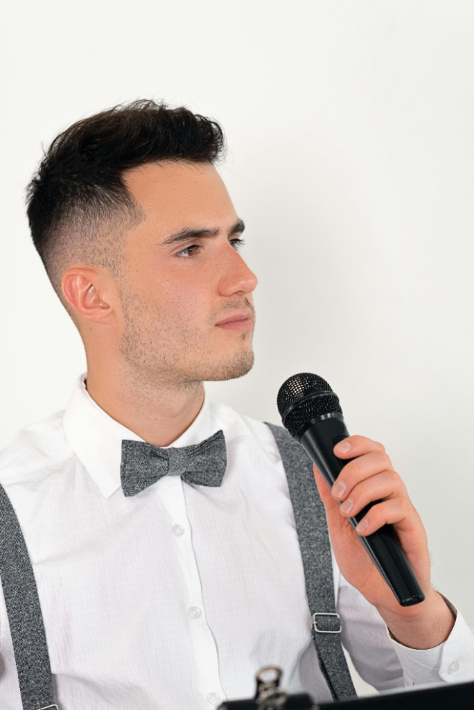 Person holding a microphone.