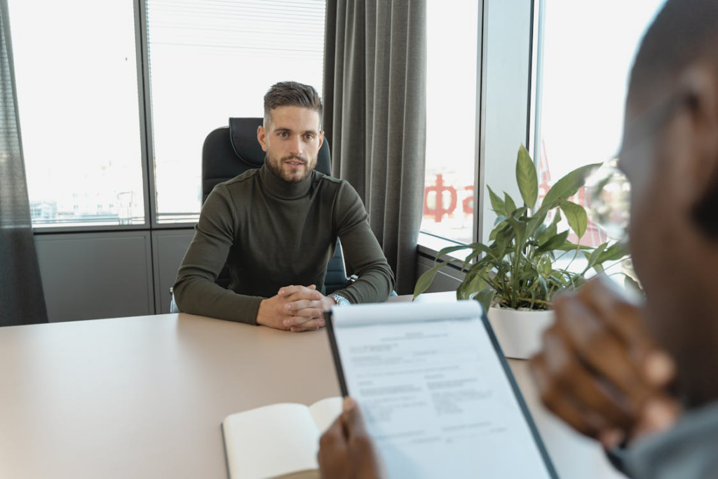 man in black long sleeve shirt sitting on chair