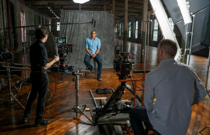 A picture of a person being recorded in a studio