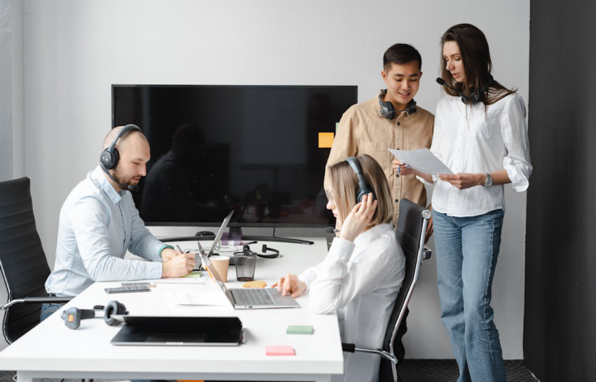 photo of a group of people with headsets in an office