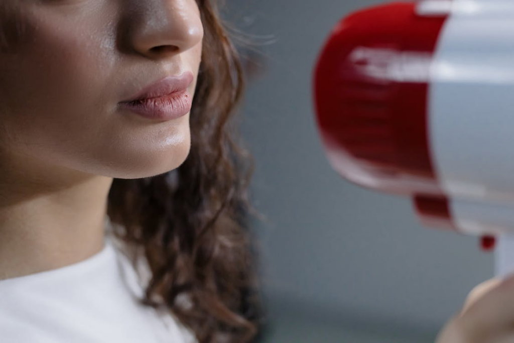 close up of megaphone by woman face