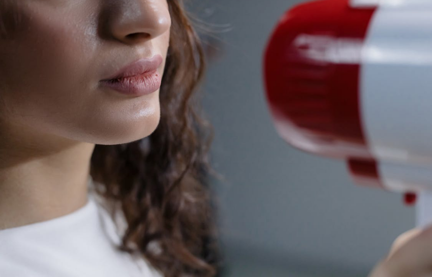 close up of megaphone by woman face
