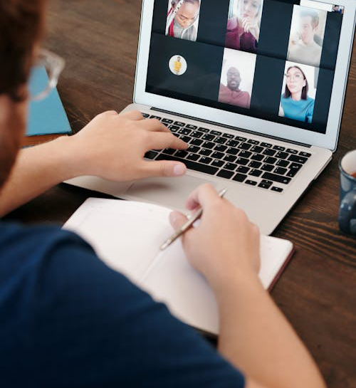 man in blue shirt having a virtual meeting