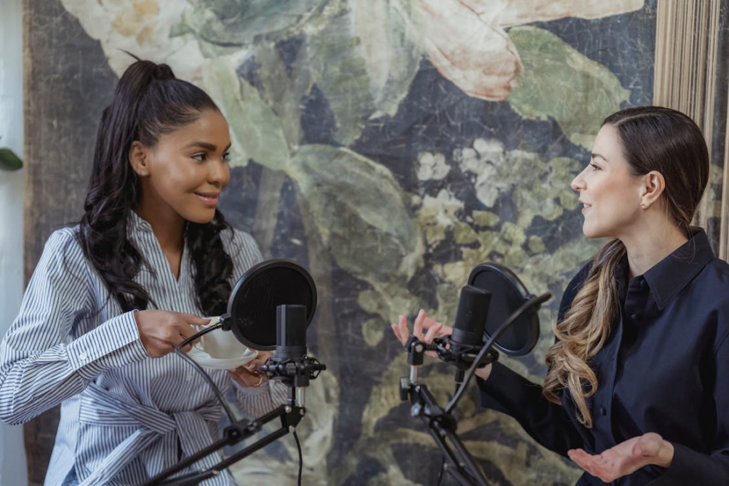 women having conversation in front of the condenser microphone