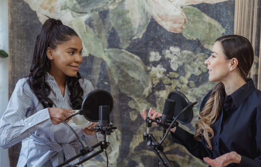 women having conversation in front of the condenser microphone